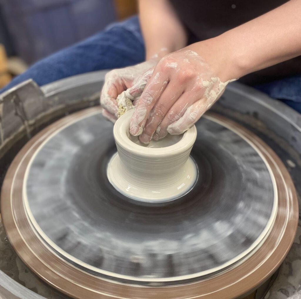 Forming a clay vessel on a wheel